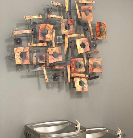 water fountains with wall art
